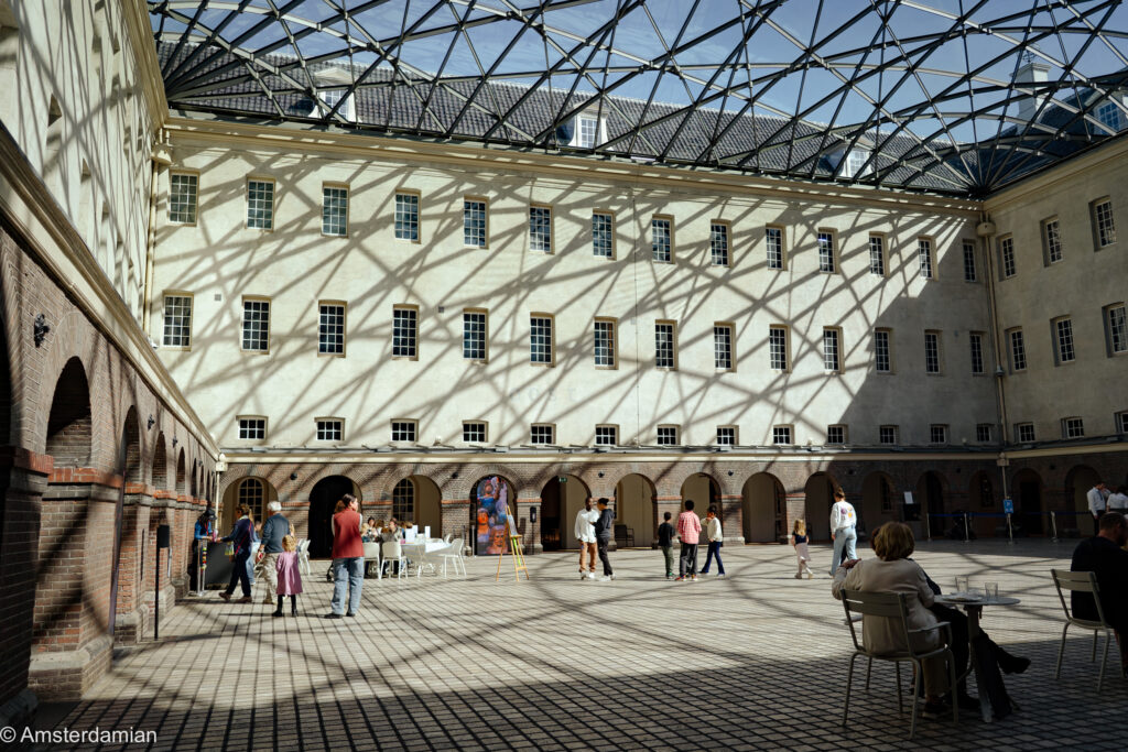 The interior courtyard at the Maritime Museum Amsterdam, with the glass ceiling casting shadows over the building