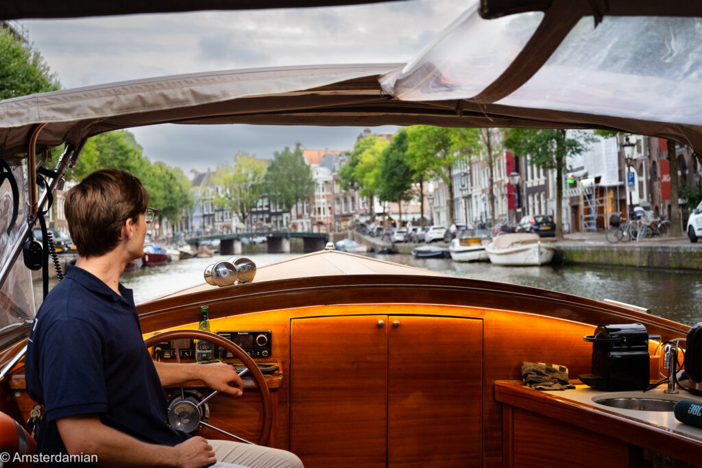 Captain at the wheel on an Amsterdam canal cruise