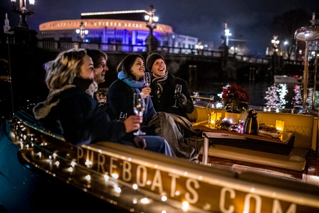 People enjoying Amsterdam Light Festival from a Pure Boats cruise