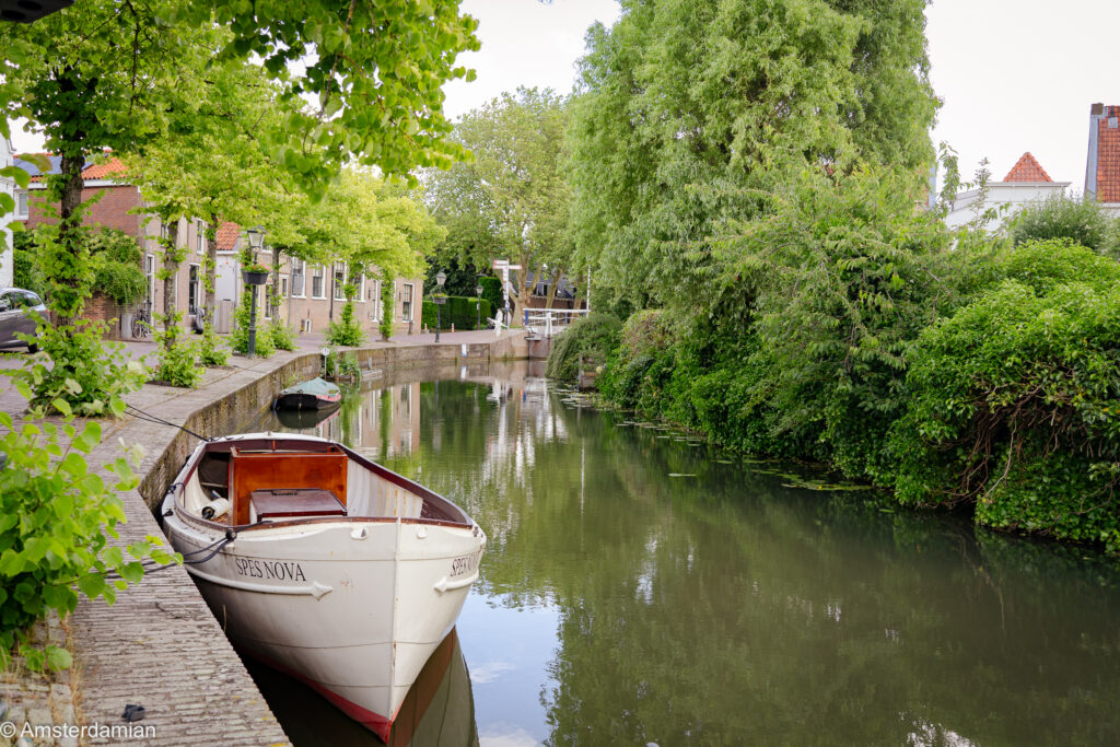 White boat moored on a green canal in Oudewater