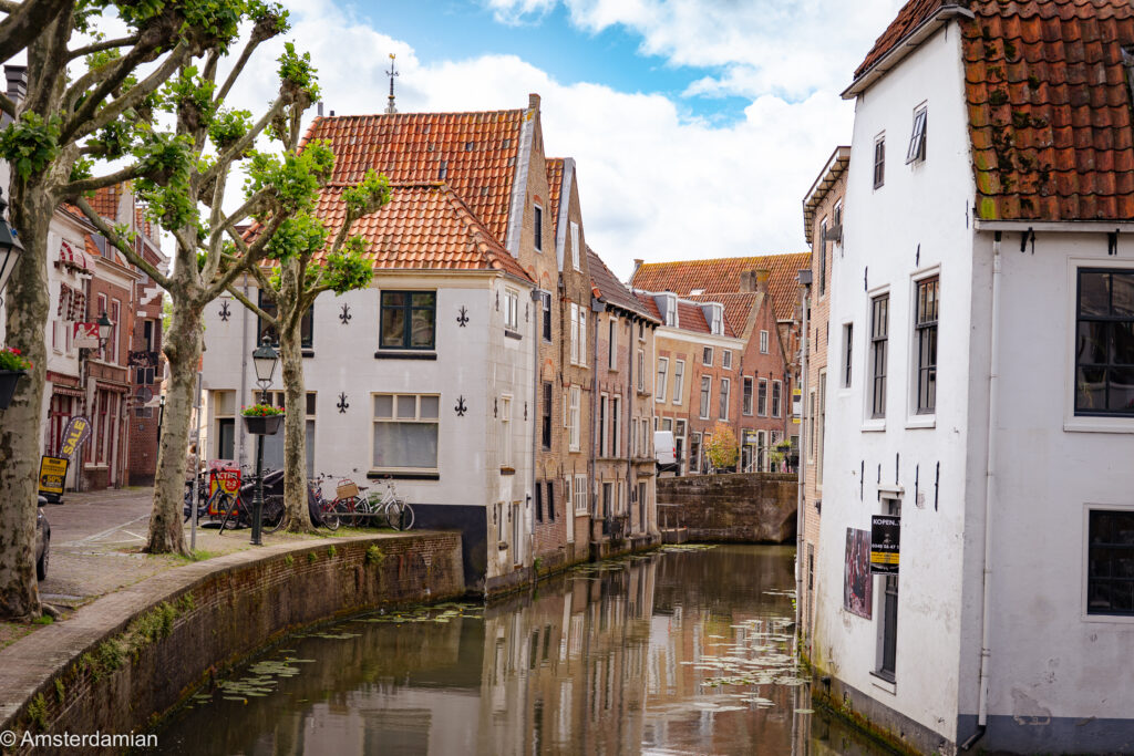 Old houses with red-tiled roofs along a canal in Oudewater