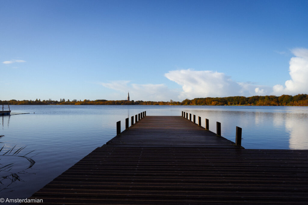 Wooden jetty reaching into the still water of De Poel lake in Amstelveen